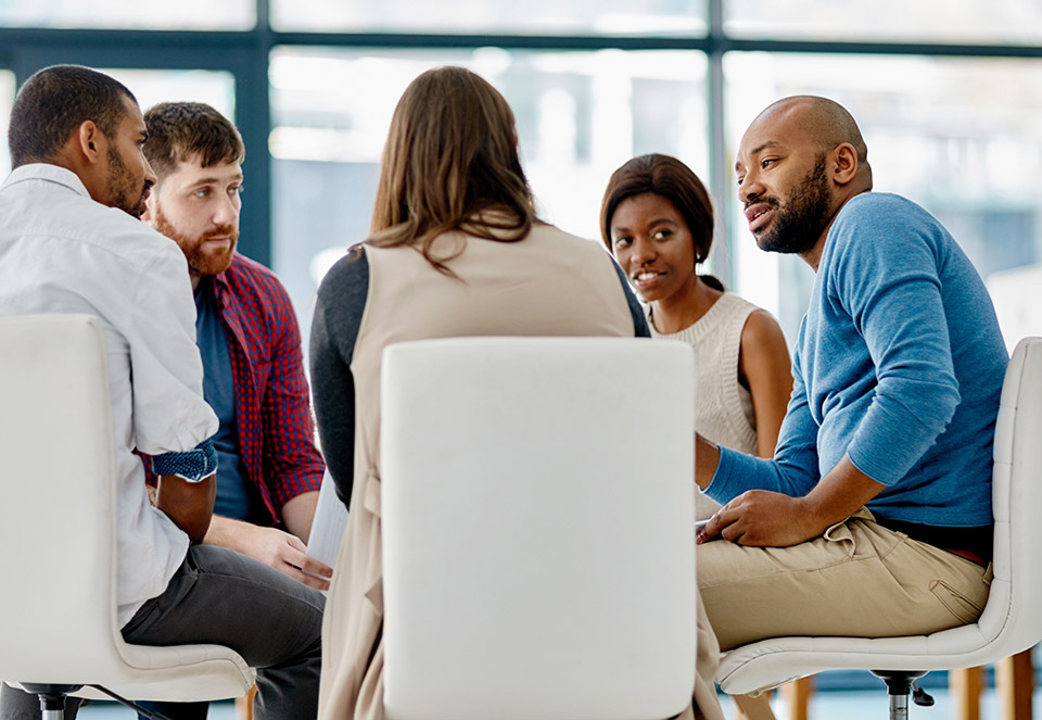 adults sitting around table